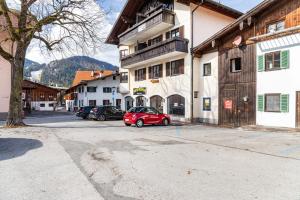 a red car parked in front of a building at Ammerstube Oberammergau in Oberammergau