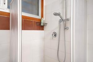 a shower with a shower head in a bathroom at Terrazza Sivori in Bonassola +22 photos