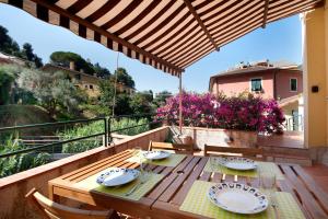 a wooden table on the balcony of a house at Terrazza Sivori in Bonassola