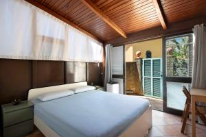 a bedroom with a bed and a table and a window at Terrazza Sivori in Bonassola