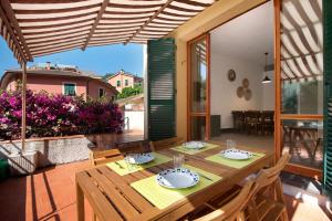 a dining room with a table and chairs on a patio at Terrazza Sivori in Bonassola