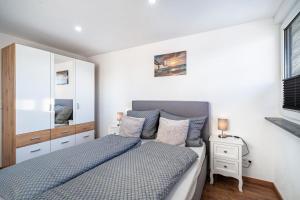 a bedroom with a bed and a mirror at Schorsch's Ferienhaus in Winzeln
