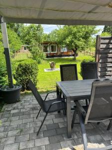 a picnic table and chairs under an umbrella on a patio at Schorsch's Ferienhaus in Winzeln