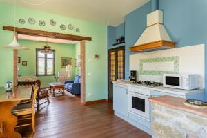 a kitchen and living room with a stove top oven at Alba al Rifugio Arcobaleno in Popiglio