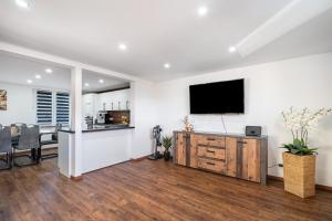 a living room with a flat screen tv on a wall at Schorsch's Ferienhaus in Winzeln