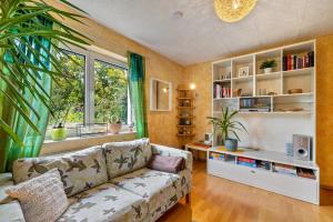 a living room with a couch and a window at Schönes Zimmer mit eigenem Bad in Albstadt
