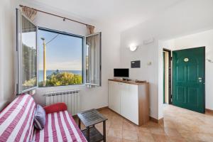 a bedroom with a bed and a large window at Agriturismo La Realidad in Finale Ligure