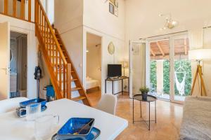 a living room with a staircase and a living room at Charming 2 bedroom House With Pool in Eyguières