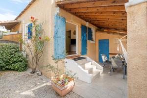 a patio with a white tub and a blue door at Charming 2 bedroom House With Pool in Eyguières