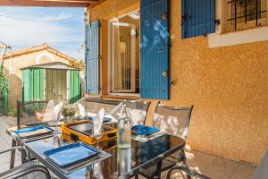 a table and chairs on the patio of a house at Charming 2 bedroom House With Pool in Eyguières