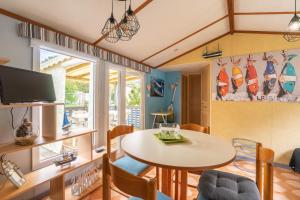 a living room with a table and chairs at Mobilhome Mh 212 in La Tremblade