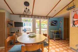 a dining room with a table and chairs at Mobilhome Mh 212 in La Tremblade
