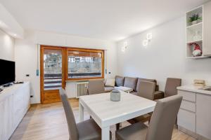 a kitchen and living room with a table and chairs at Casa Gianpaolo in Piode