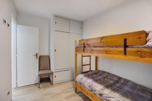 a bedroom with a bunk bed and a chair at Casa Gianpaolo in Piode