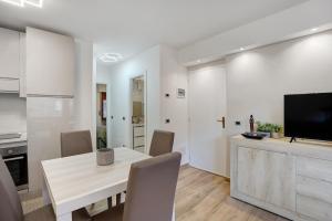 a kitchen and dining room with a table and a tv at Casa Gianpaolo in Piode +12 photos