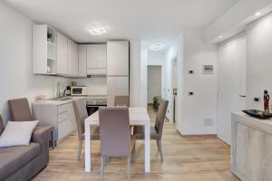 a kitchen and living room with a table and chairs at Casa Gianpaolo in Piode