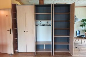 a bookcase in a room with shelves at Bahnhof Durlesbach in Bad Waldsee