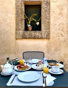 a black table with plates of food on it at Oasi di relax in Noto