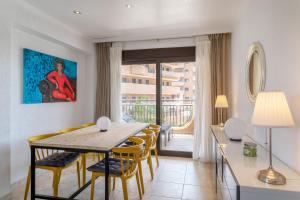 a dining room with a table and chairs at Luxury flat beach ressort sea view in Arenales del Sol