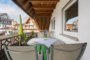a patio with a table and chairs on a balcony at Pension Deutscher Hof in Oberbiederbach