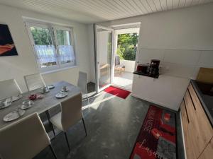 a kitchen and dining room with a table and chairs at Ferienwohnung Karbachtal in Wangen im Allgäu