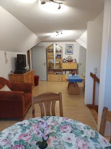 a living room with a table and a couch at Ferienwohnung Schiemann in Krienke