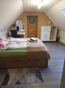 a bedroom with a bed in a attic at Ferienwohnung Schiemann in Krienke