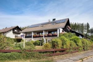 a house with solar panels on top of it at Apartmenthaus Fister in Schluchsee