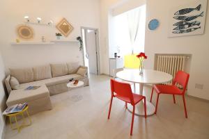 a living room with a couch and a table and chairs at Casa vacanze Aura a Otranto in Otranto +27 photos