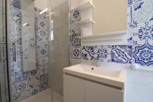 a blue and white bathroom with a sink and a shower at Casa vacanze Aura a Otranto in Otranto