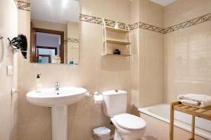 a bathroom with a sink and a toilet and a tub at Vejer 1 - Andalmar in Vejer de la Frontera +12 photos