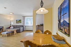 a living room with a table and a couch at Fewo Brünnstein - Nr 5 Pool, Sauna in Oberaudorf