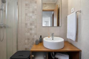 a bathroom with a white sink and a shower at Nuria House in Praia da Vitória +19 photos