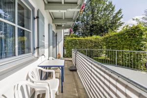 a patio with a table and chairs on a balcony at Fewo Brünnstein - Nr 5 Pool, Sauna in Oberaudorf