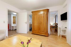 a living room with a wooden cabinet and a table at Thum in Daisendorf