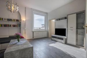 a living room with a television and a large window at Braunlageblick in Braunlage