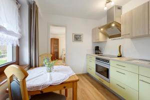 a kitchen with a wooden table and a small dining room at Thum in Daisendorf