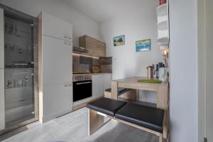 a kitchen with a small table with a bench in it at Braunlageblick in Braunlage