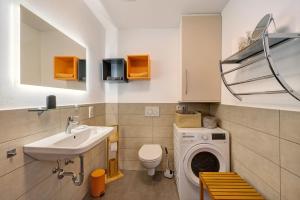 a bathroom with a sink and a washing machine at Wohlfühlhaus in Freiamt +49 photos