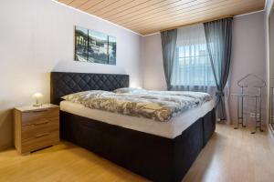 a bedroom with a large bed and a window at Ferienwohnung K Schröder in Sundhagen-Niederhof