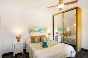 a bedroom with two beds and a large mirror at Casa Los Caideros in Los Caideros +22 photos