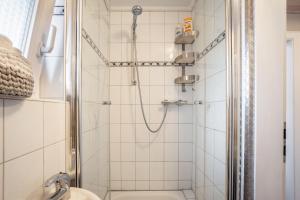 a bathroom with a shower with a toilet at Ferienwohnung Dahmlos in Kremperheide +20 photos