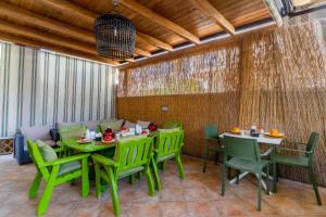 a dining room with green tables and chairs at Mini Appartamento verde in Gallipoli +21 photos