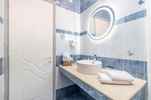 a bathroom with a sink and a mirror at Spyridoula Studio 3 in Paleokastritsa +14 photos