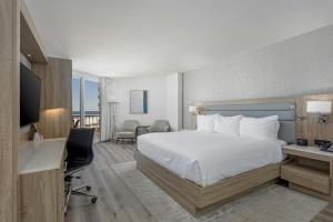 a hotel room with a large bed and a desk at Perdido Beach Resort in Orange Beach +67 photos