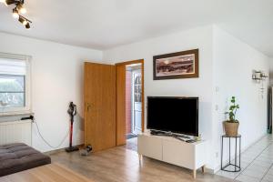 a living room with a large flat screen tv at Ferienwohnung An der Haferkoppel in Groß Kussewitz