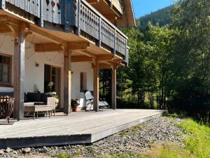 a porch of a house with a wooden deck at Ferienwohnung am Nettenbach in Bernau im Schwarzwald