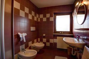 a bathroom with a toilet and a sink at Apartment 7 - Zur Sonne in Laion +14 photos