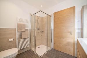 a bathroom with a shower and a toilet at City Apartment Flora in Merano +15 photos