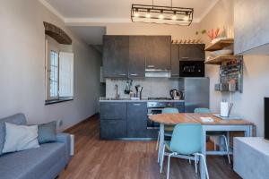 a kitchen and living room with a table and a couch at La casina di Kino in Lucca